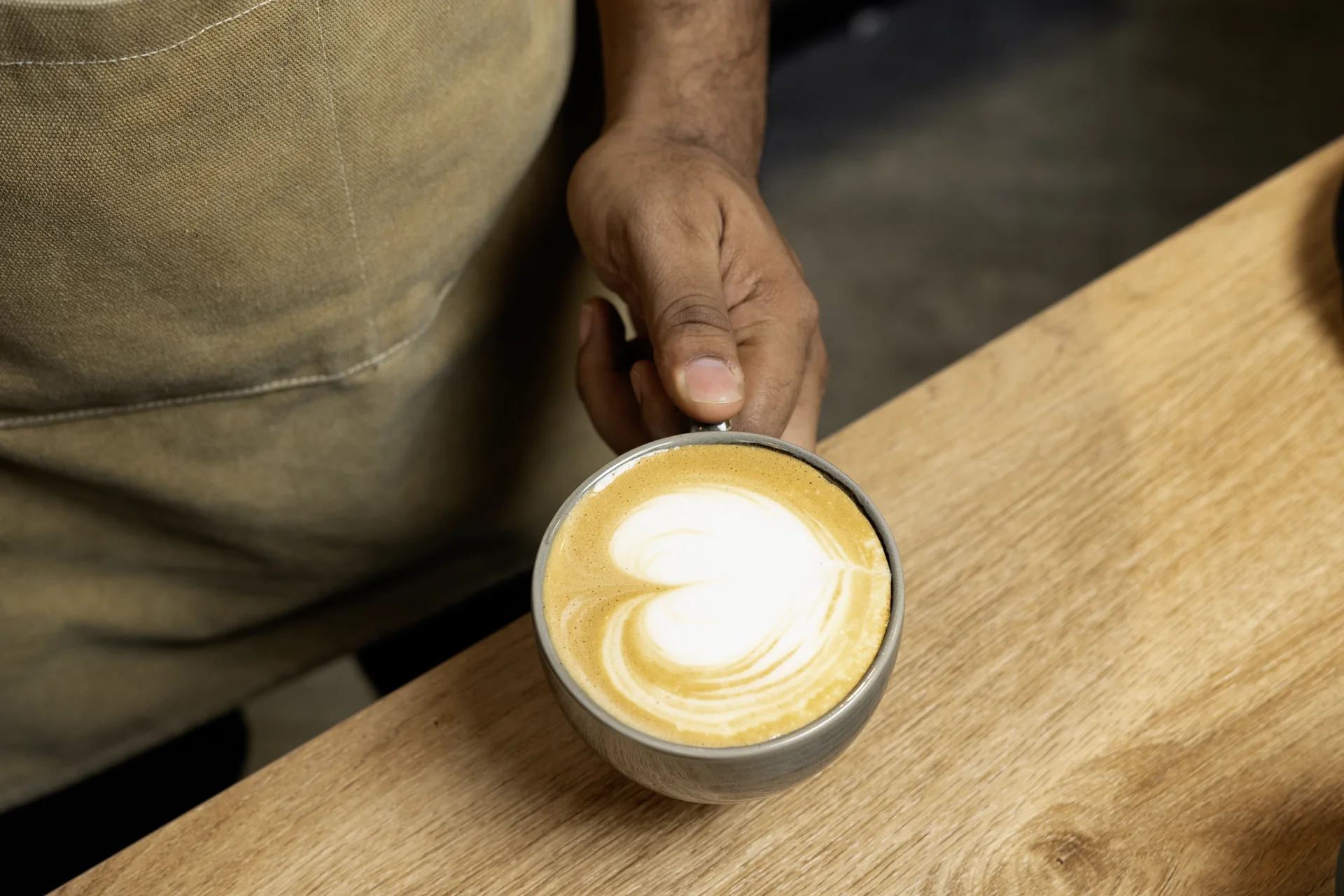 A cup of latte art coffee made at La Pandora Coffee