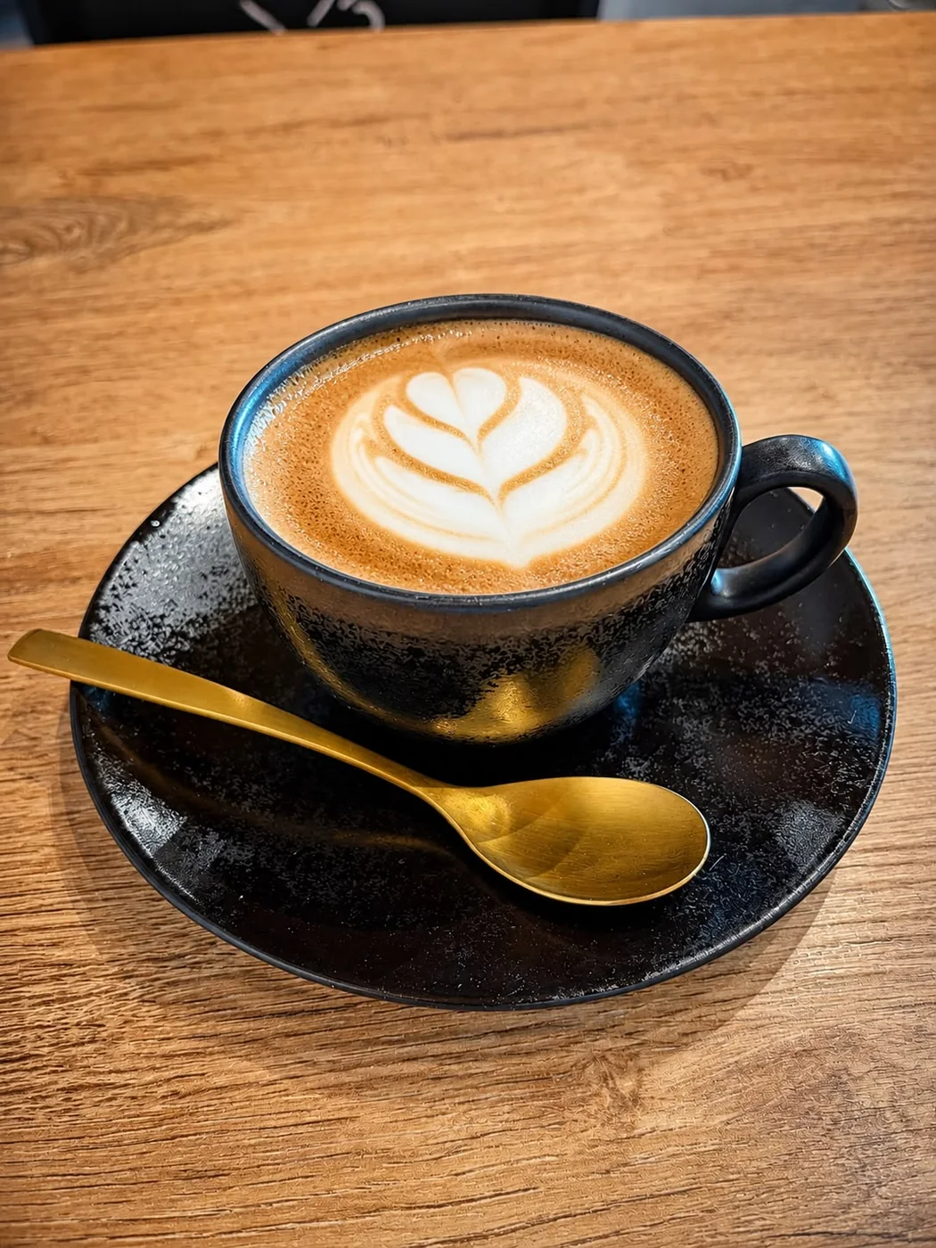 La Pandora Coffee cup on a wooden table
